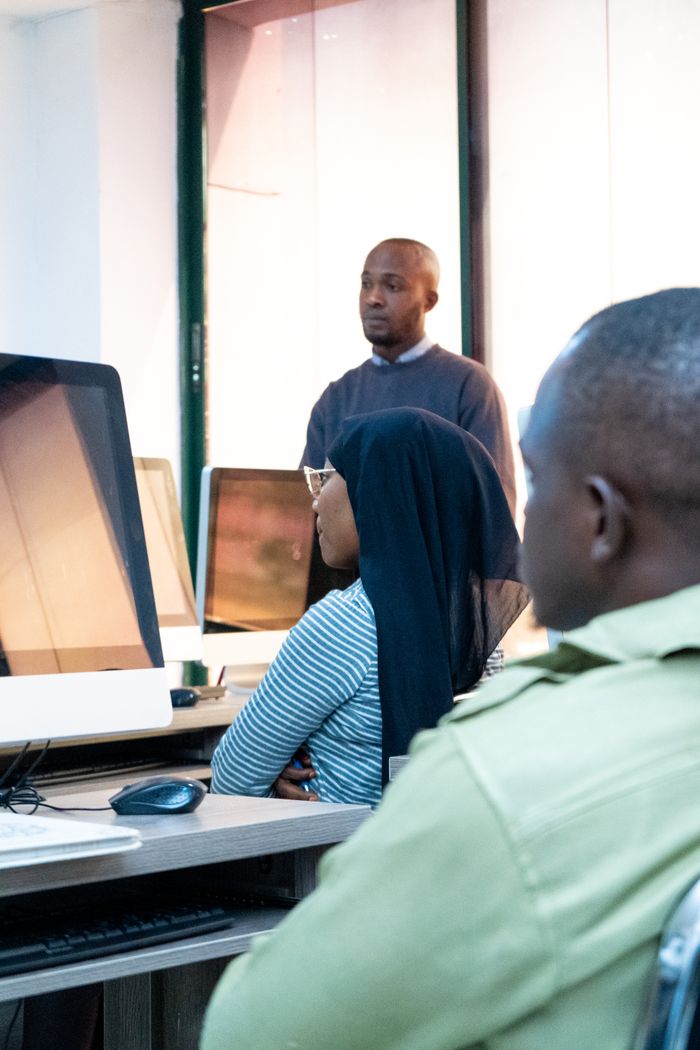 About Students engaging in coding at a modern computer lab with a focus on ICT skills.